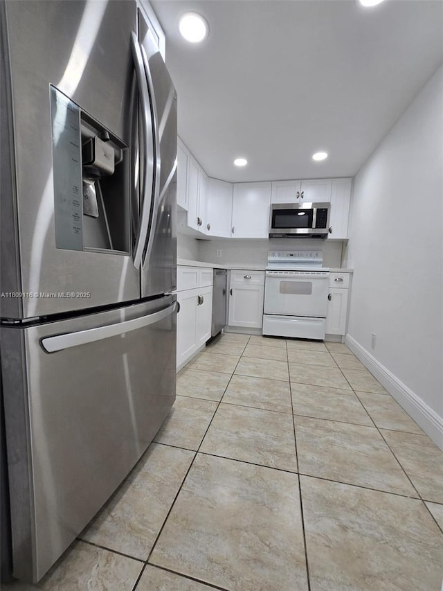 200 SE 15th Rd Unit 6B, Miami, FL 33129 - kitchen featuring appliances with stainless steel finishes, white cabinetry, light countertops, light tile patterned floors, and baseboards