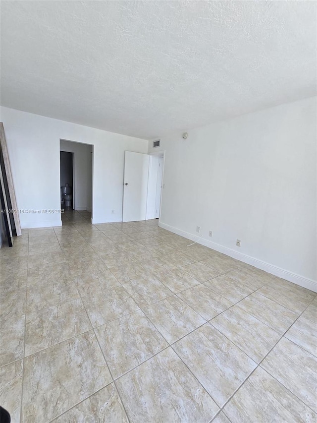 200 SE 15th Rd Unit 6B, Miami, FL 33129 - unfurnished room with a textured ceiling and baseboards