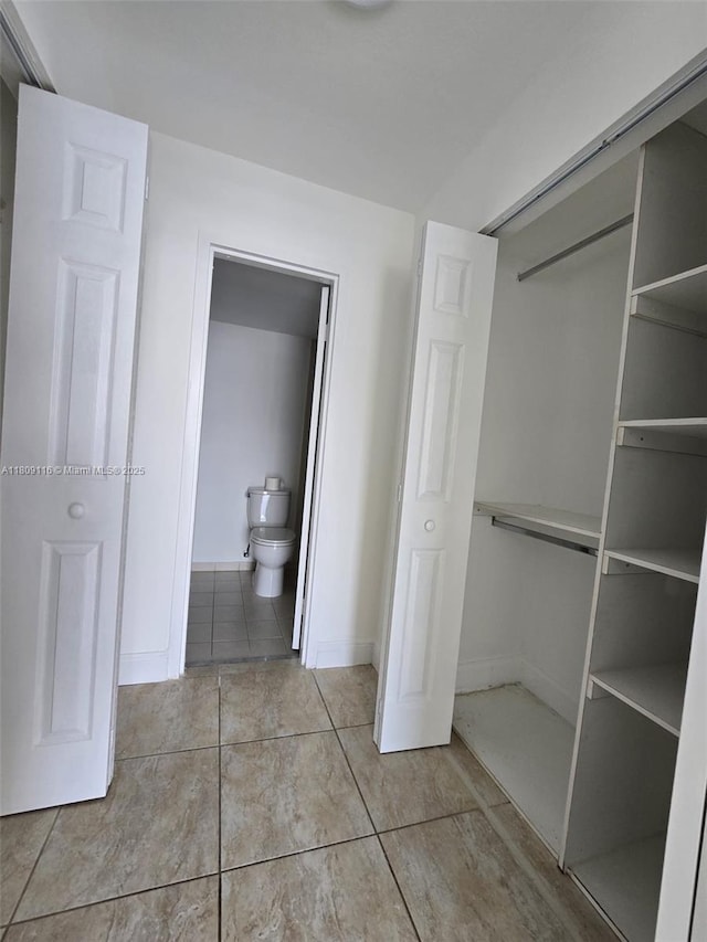 200 SE 15th Rd Unit 6B, Miami, FL 33129 - unfurnished bedroom featuring tile patterned floors, baseboards, a closet, and connected bathroom
