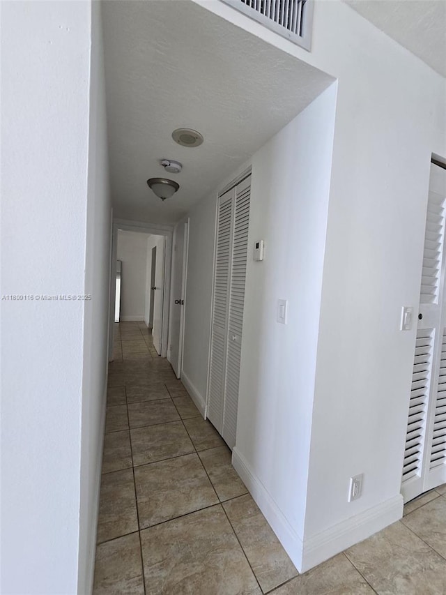 200 SE 15th Rd Unit 6B, Miami, FL 33129 - hall with light tile patterned floors and baseboards