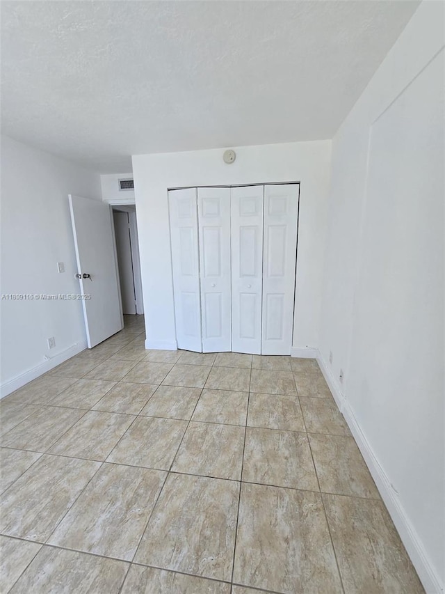 200 SE 15th Rd Unit 6B, Miami, FL 33129 - unfurnished bedroom featuring a closet and baseboards