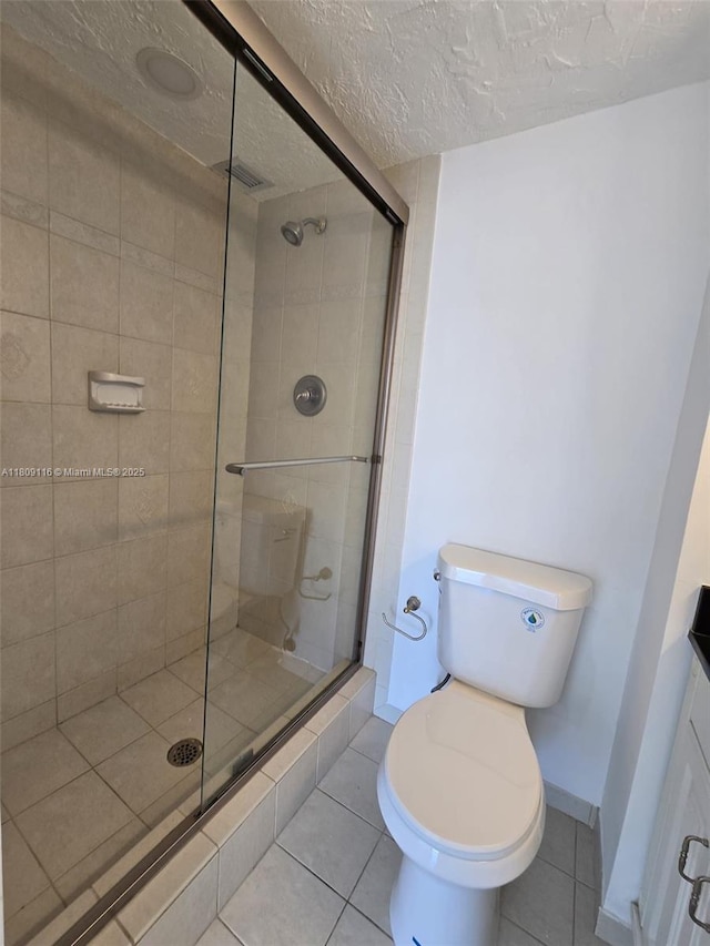 200 SE 15th Rd Unit 6B, Miami, FL 33129 - bathroom with a stall shower, tile patterned floors, toilet, a textured ceiling, and baseboards