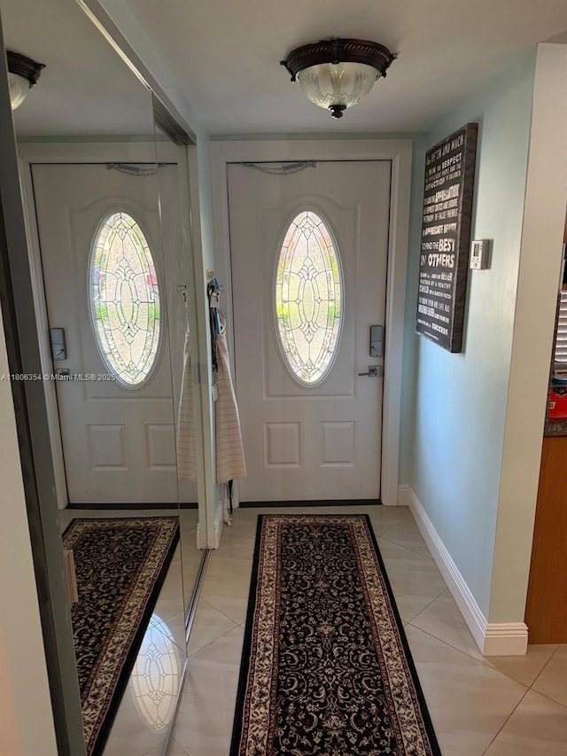 7680 NW 1st St Unit 108, Margate, FL 33063 - foyer entrance featuring light tile patterned floors, healthy amount of natural light, and baseboards
