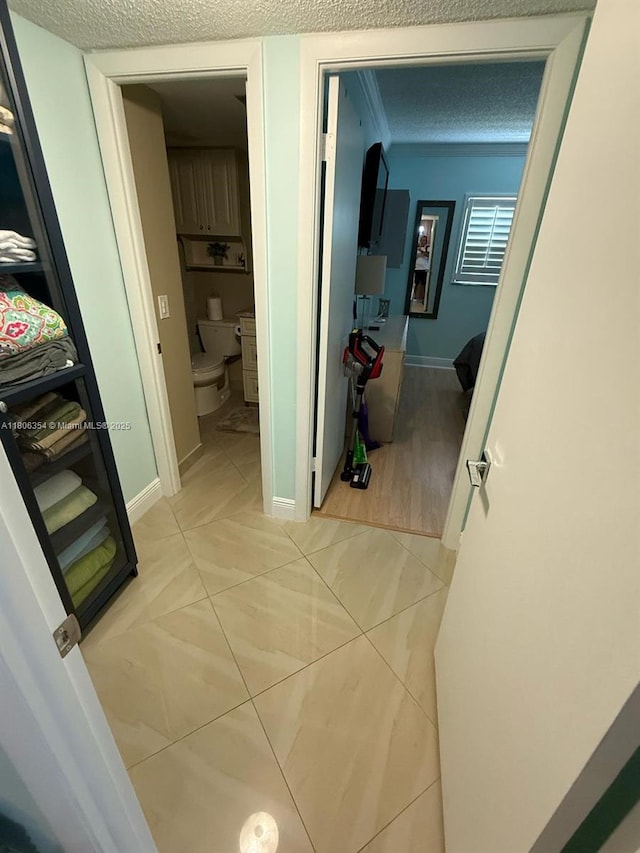 7680 NW 1st St Unit 108, Margate, FL 33063 - corridor featuring a textured ceiling and baseboards