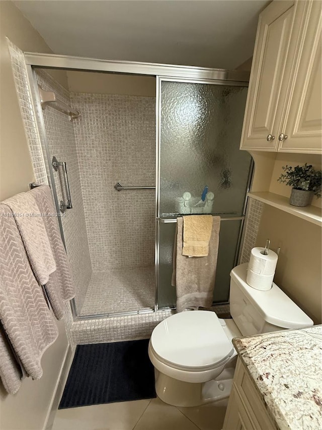 7680 NW 1st St Unit 108, Margate, FL 33063 - bathroom featuring vanity, a stall shower, toilet, and tile patterned floors