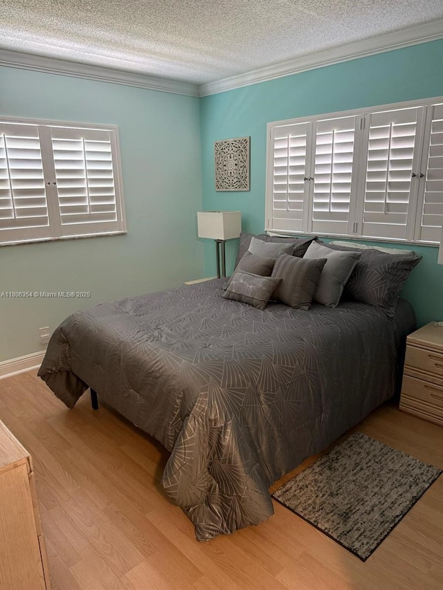 7680 NW 1st St Unit 108, Margate, FL 33063 - bedroom with wood finished floors, crown molding, and a textured ceiling