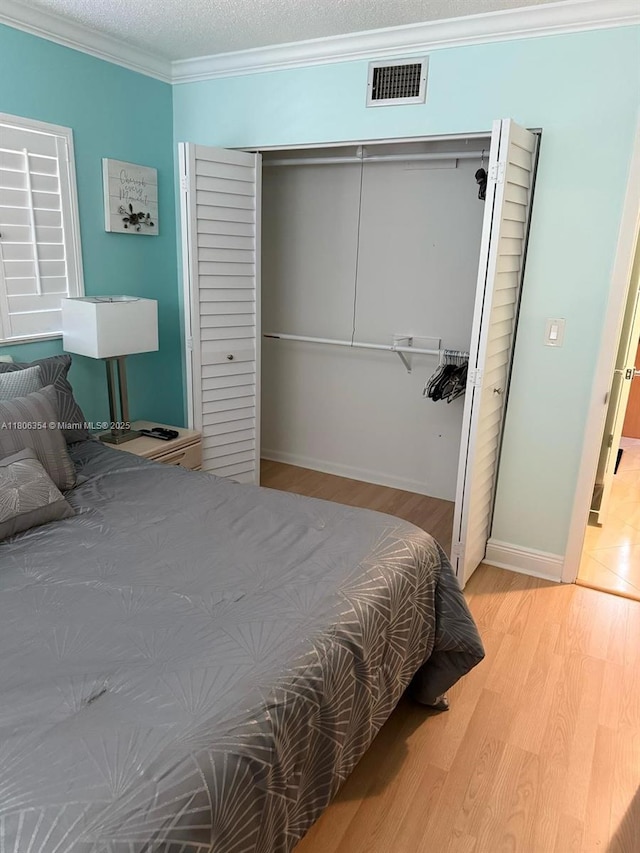 7680 NW 1st St Unit 108, Margate, FL 33063 - bedroom with a closet, wood finished floors, ornamental molding, and baseboards