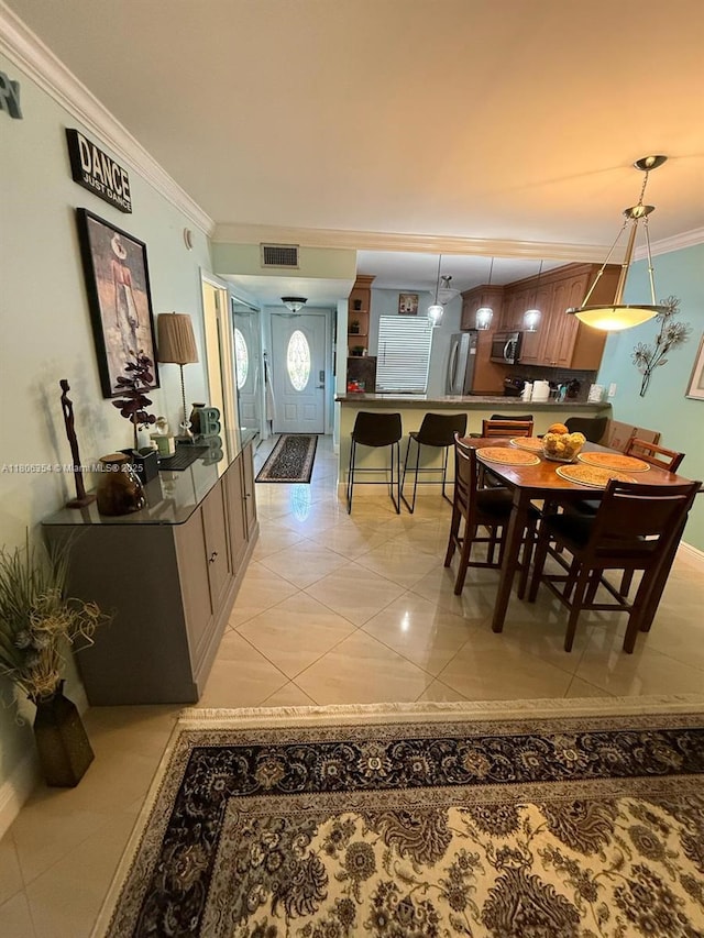 7680 NW 1st St Unit 108, Margate, FL 33063 - dining space with light tile patterned floors, ornamental molding, and baseboards