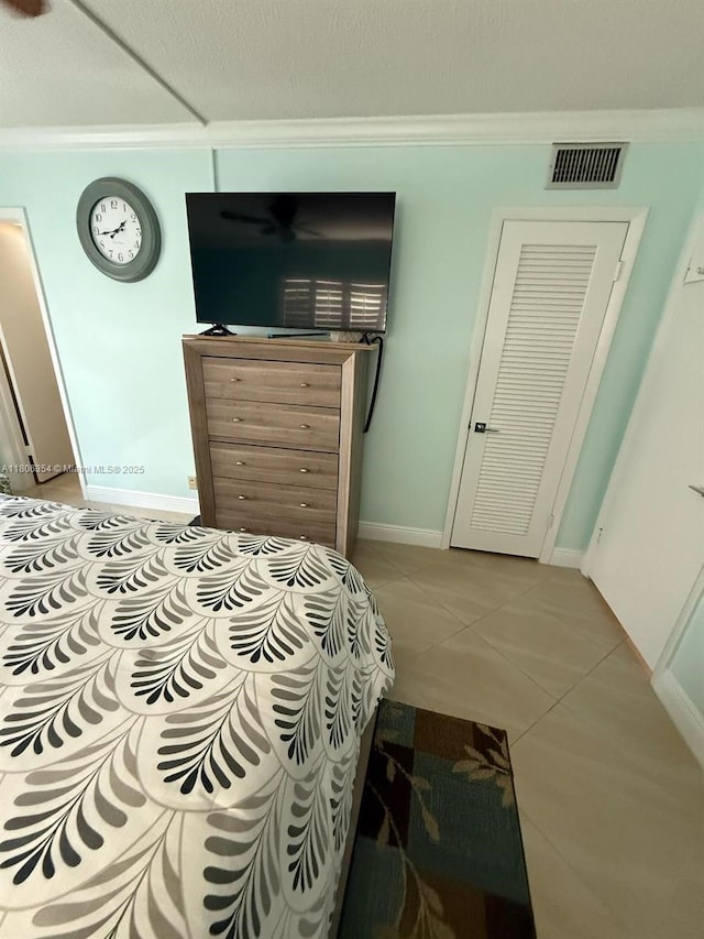 7680 NW 1st St Unit 108, Margate, FL 33063 - bedroom featuring crown molding, light tile patterned floors, and baseboards