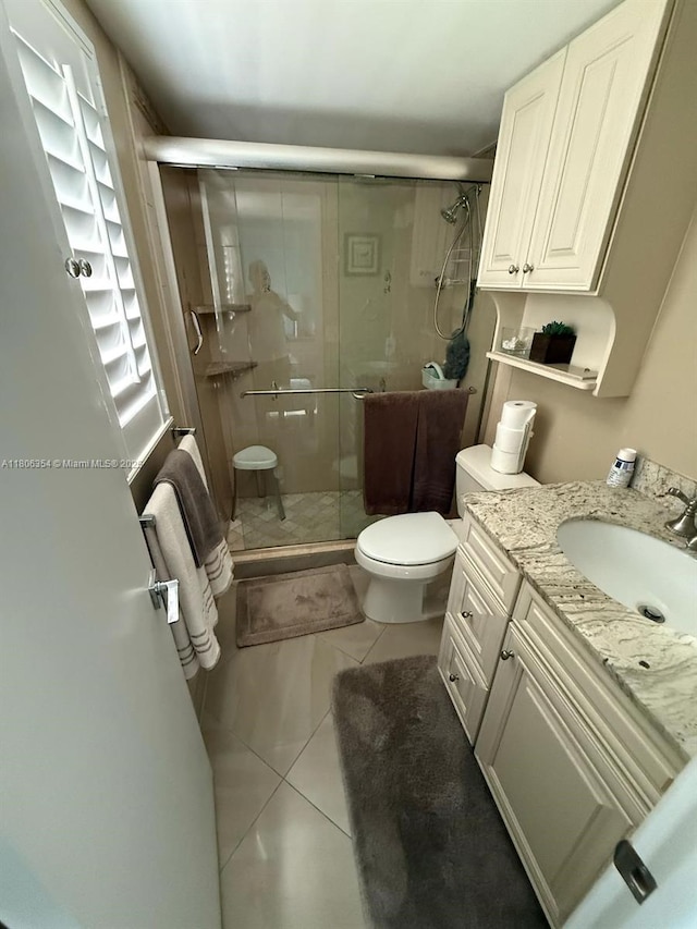7680 NW 1st St Unit 108, Margate, FL 33063 - full bathroom featuring tile patterned flooring, a shower stall, vanity, and toilet