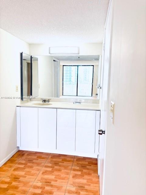 210 174th St Unit 818, Sunny Isles Beach, FL 33160 - full bath featuring double vanity, a textured ceiling, baseboards, and wood finished floors
