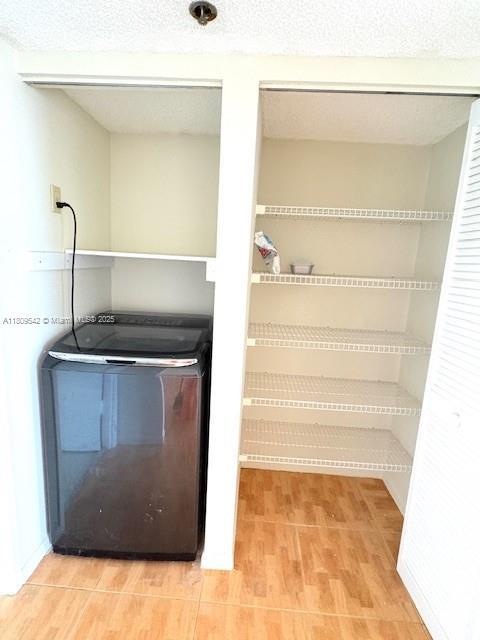 210 174th St Unit 818, Sunny Isles Beach, FL 33160 - detailed view of washer / clothes dryer and wood finished floors
