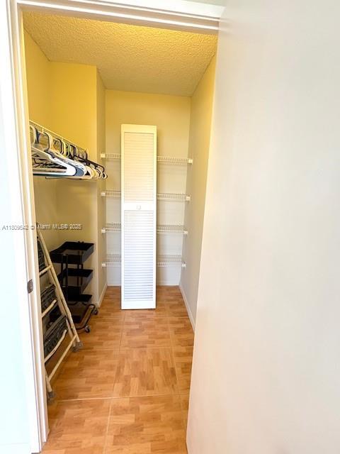 210 174th St Unit 818, Sunny Isles Beach, FL 33160 - walk in closet featuring light wood finished floors
