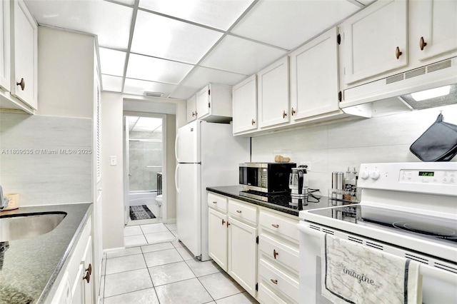 3660 Inverrary Dr Unit 2X, Lauderhill, FL 33319 - kitchen with white appliances, light tile patterned floors, under cabinet range hood, white cabinets, and a sink