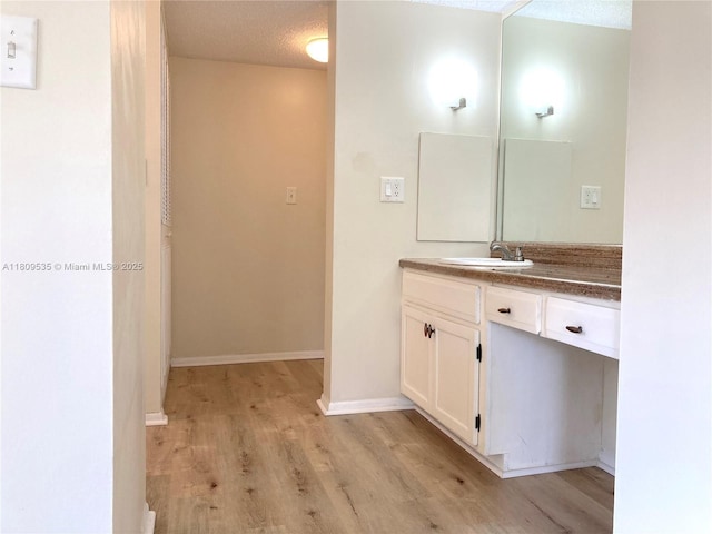 3660 Inverrary Dr Unit 2X, Lauderhill, FL 33319 - bathroom with vanity, wood finished floors, and baseboards