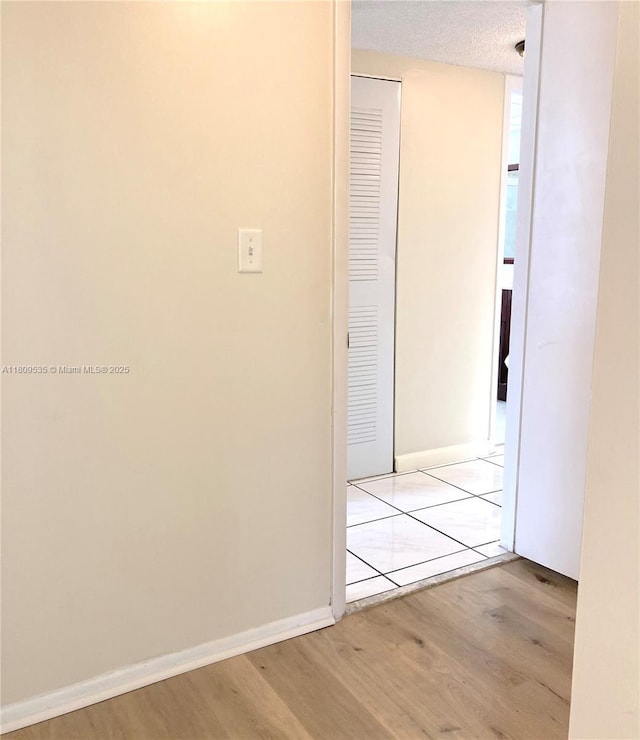 3660 Inverrary Dr Unit 2X, Lauderhill, FL 33319 - corridor featuring wood finished floors, baseboards, and a textured ceiling