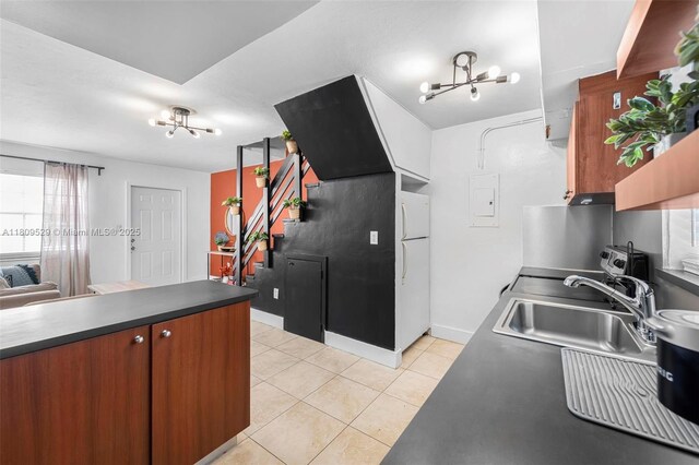 938 SW 6th St Unit 8, Miami, FL 33130 - kitchen with a chandelier, a sink, freestanding refrigerator, light tile patterned floors, and electric panel