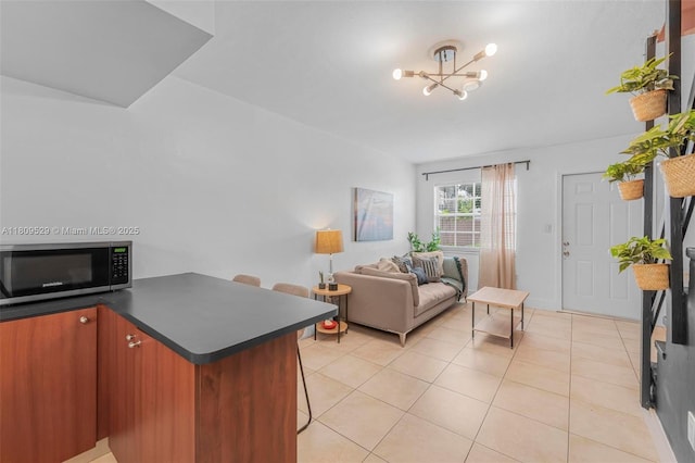938 SW 6th St Unit 8, Miami, FL 33130 - living area with light tile patterned flooring and a chandelier