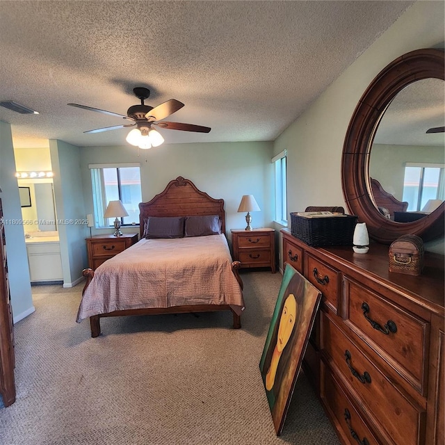 5542 Courtyard Dr Unit 5542, Margate, FL 33063 - bedroom featuring light carpet, multiple windows, a textured ceiling, ceiling fan, and ensuite bath