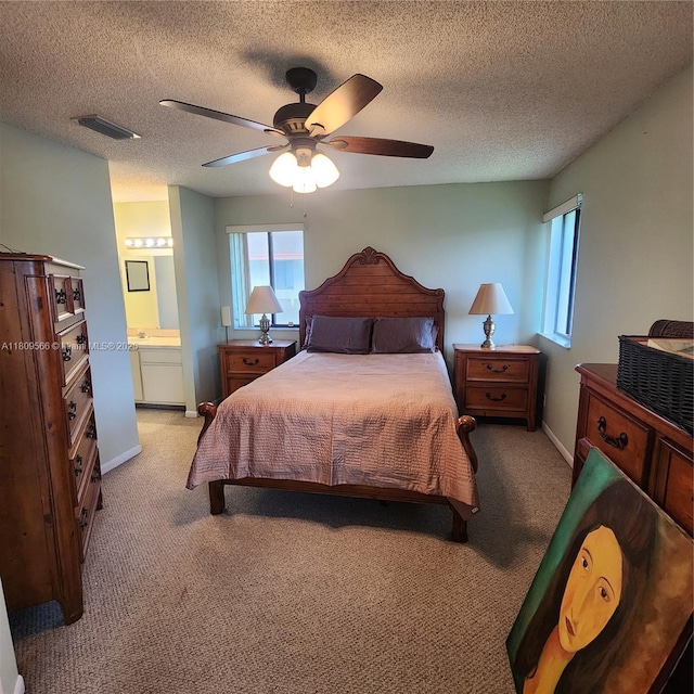 5542 Courtyard Dr Unit 5542, Margate, FL 33063 - bedroom with light colored carpet, ceiling fan, connected bathroom, and a textured ceiling