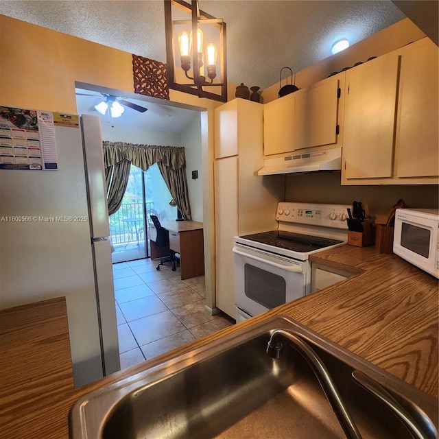 5542 Courtyard Dr Unit 5542, Margate, FL 33063 - kitchen with white appliances, under cabinet range hood, a ceiling fan, a desk, and a textured ceiling