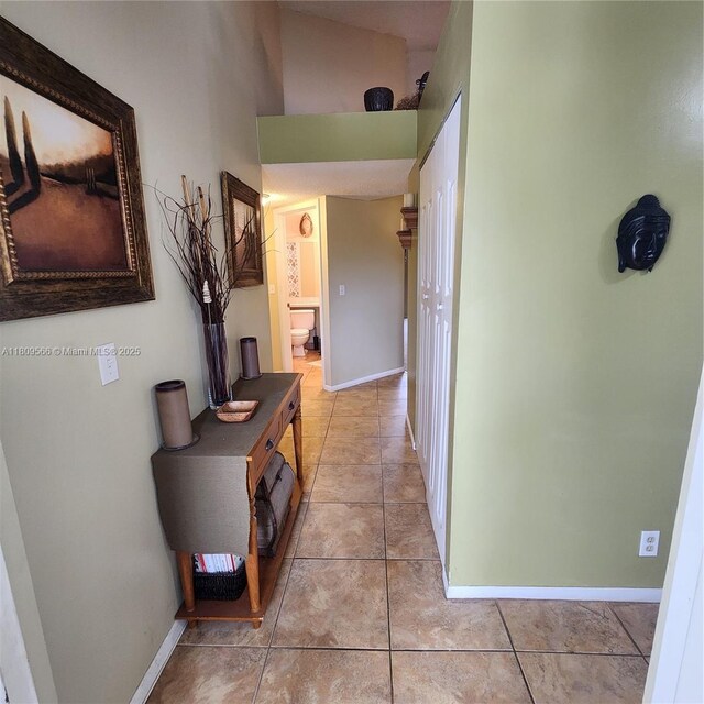 5542 Courtyard Dr Unit 5542, Margate, FL 33063 - hallway featuring light tile patterned flooring and a towering ceiling