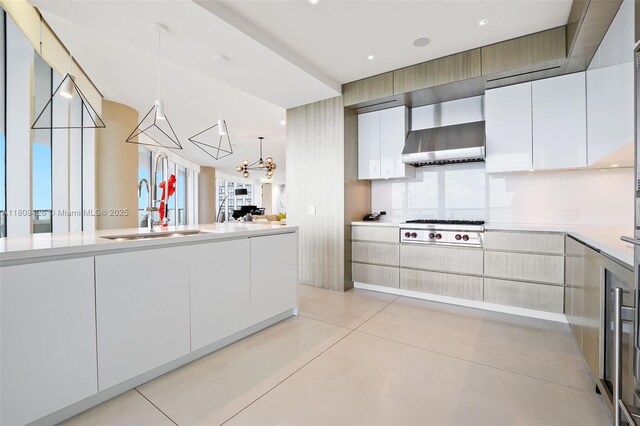 9703 Collins Ave Unit 1700, Bal Harbour, FL 33154 - kitchen with stainless steel gas stovetop, light countertops, white cabinetry, and concrete floors