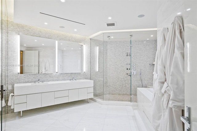 9703 Collins Ave Unit 1700, Bal Harbour, FL 33154 - bathroom with double vanity, a stall shower, a tub, recessed lighting, and tile walls