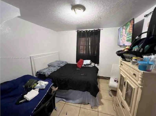 2279 NW 48th St, Miami, FL 33142 - bedroom featuring a textured ceiling and light tile patterned floors