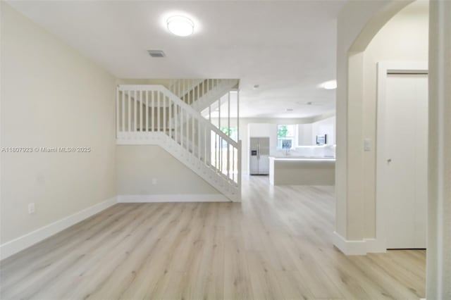 8144 NW 107th Path, Doral, FL 33178 - entrance foyer with light wood finished floors, baseboards, stairway, and arched walkways