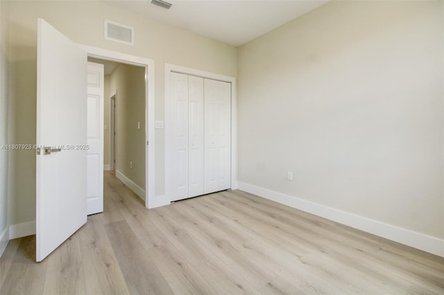 8144 NW 107th Path, Doral, FL 33178 - unfurnished bedroom featuring light wood finished floors, baseboards, and a closet