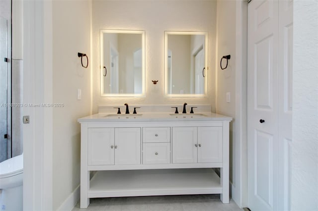 8144 NW 107th Path, Doral, FL 33178 - bathroom featuring double vanity, toilet, and baseboards