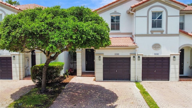 8144 NW 107th Path, Doral, FL 33178 - mediterranean / spanish house featuring a tiled roof, a garage, driveway, and stucco siding