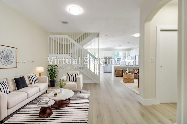 8144 NW 107th Path, Doral, FL 33178 - living area with wood finished floors, stairway, arched walkways, and baseboards