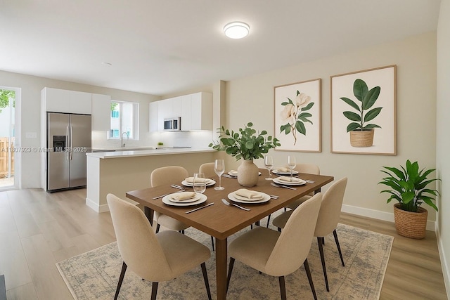 8144 NW 107th Path, Doral, FL 33178 - dining space featuring light wood-style floors and baseboards