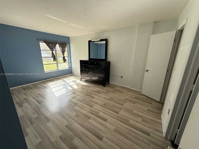 4168 Inverrary Dr Unit 111, Lauderhill, FL 33319 - unfurnished bedroom featuring wood finished floors and baseboards