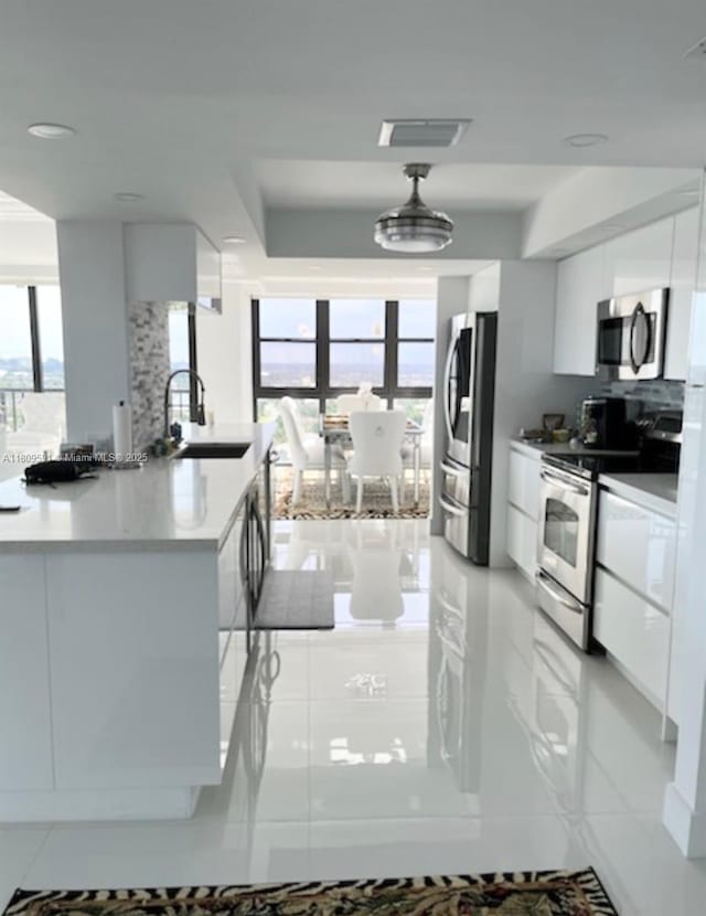 2017 S Ocean Dr Unit 1510, Hallandale Beach, FL 33009 - kitchen featuring a sink, stainless steel appliances, white cabinets, floor to ceiling windows, and modern cabinets