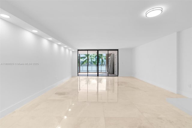 2300 Diana Dr Unit 302, Hallandale Beach, FL 33009 - unfurnished room with a wall of windows, recessed lighting, and baseboards