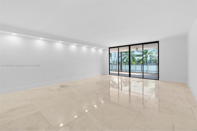 2300 Diana Dr Unit 302, Hallandale Beach, FL 33009 - empty room with a wall of windows, marble finish floors, and baseboards
