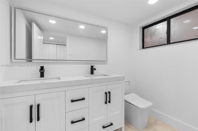2300 Diana Dr Unit 302, Hallandale Beach, FL 33009 - bathroom with recessed lighting, toilet, double vanity, and baseboards