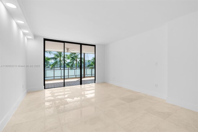 2300 Diana Dr Unit 302, Hallandale Beach, FL 33009 - spare room featuring floor to ceiling windows, recessed lighting, and baseboards