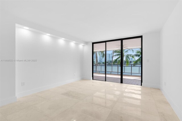 2300 Diana Dr Unit 302, Hallandale Beach, FL 33009 - spare room featuring expansive windows and baseboards