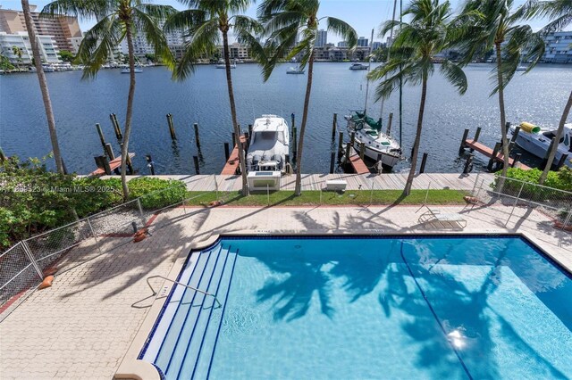 2300 Diana Dr Unit 302, Hallandale Beach, FL 33009 - view of pool featuring boat lift, a water view, and a dock