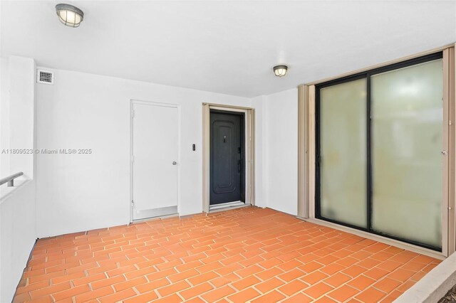 2300 Diana Dr Unit 302, Hallandale Beach, FL 33009 - spare room featuring brick patterned flooring
