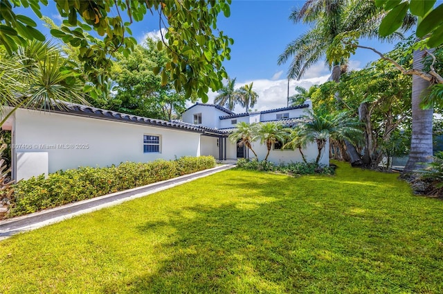 5757 Alton Rd, Miami Beach, FL 33140 - view of front facade featuring stucco siding and a front yard