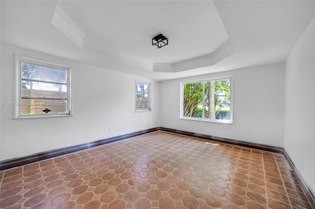 5757 Alton Rd, Miami Beach, FL 33140 - unfurnished room featuring baseboards and a tray ceiling