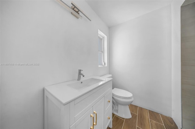 5757 Alton Rd, Miami Beach, FL 33140 - bathroom with vanity, toilet, and wood finish floors