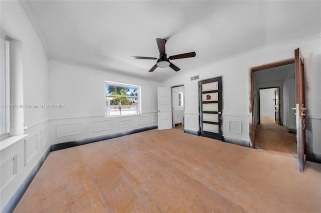 5757 Alton Rd, Miami Beach, FL 33140 - unfurnished bedroom featuring a decorative wall, wainscoting, crown molding, wood finished floors, and a ceiling fan