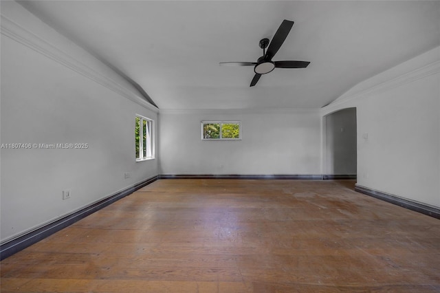 5757 Alton Rd, Miami Beach, FL 33140 - spare room with vaulted ceiling, ceiling fan, arched walkways, wood finished floors, and baseboards