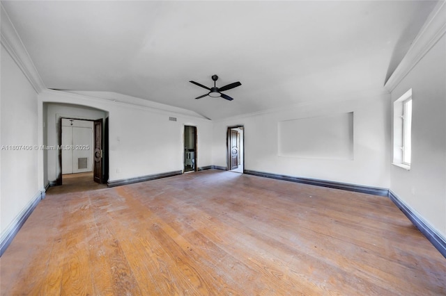 5757 Alton Rd, Miami Beach, FL 33140 - empty room featuring vaulted ceiling, ceiling fan, baseboards, arched walkways, and light wood-type flooring